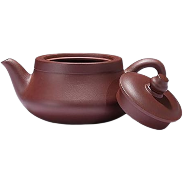 Purple Clay Yixing clay teapot with the lid leaning against it