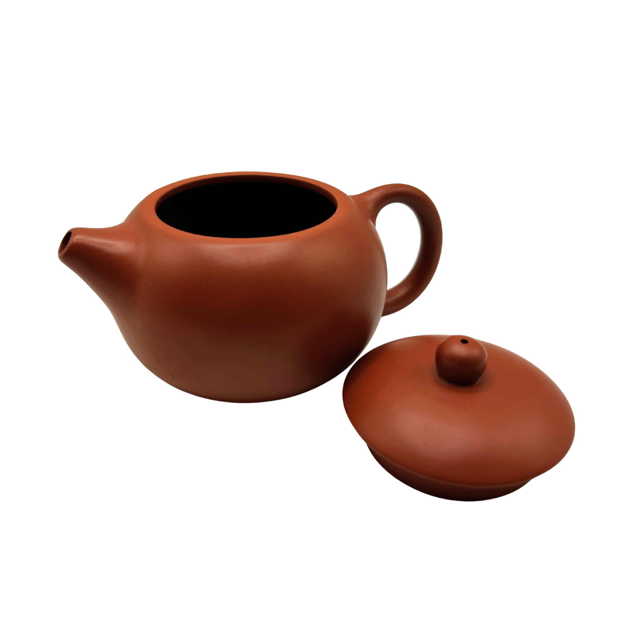 Red Yixing clay teapot with the lid on the side