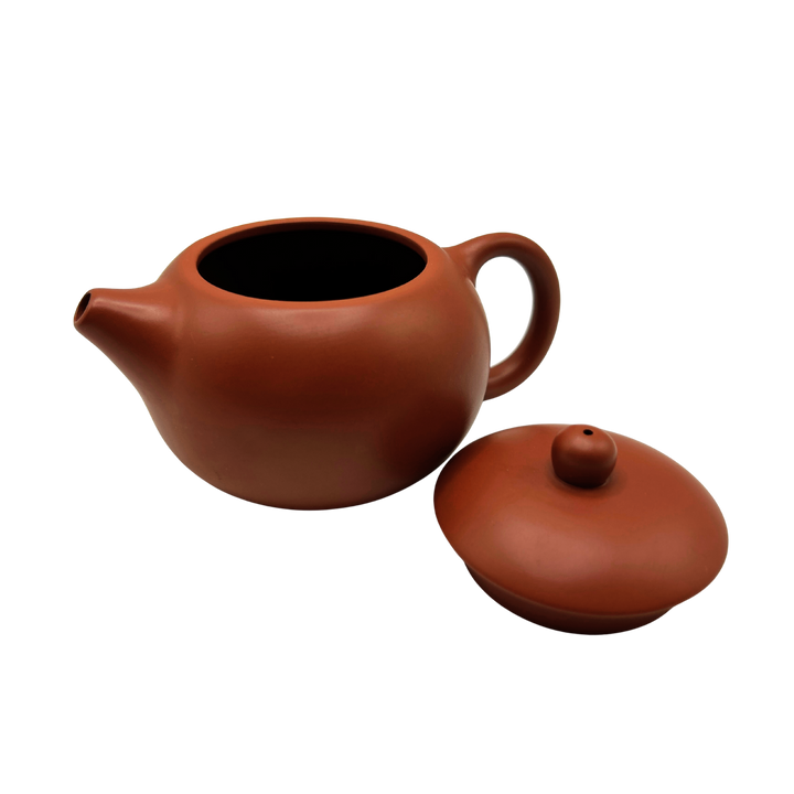 Red Yixing clay teapot with the lid on the side