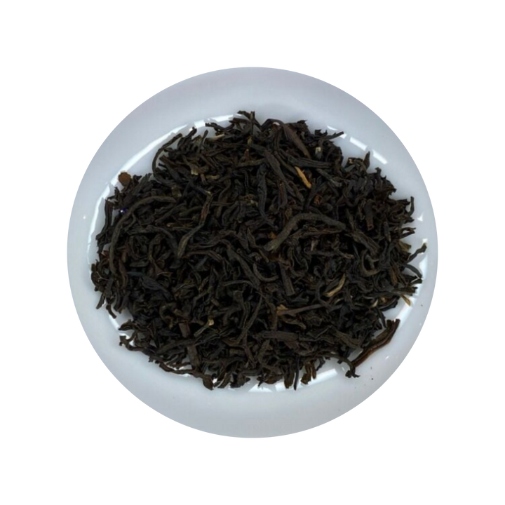 Dark Assam Tea leaves in a white bowl