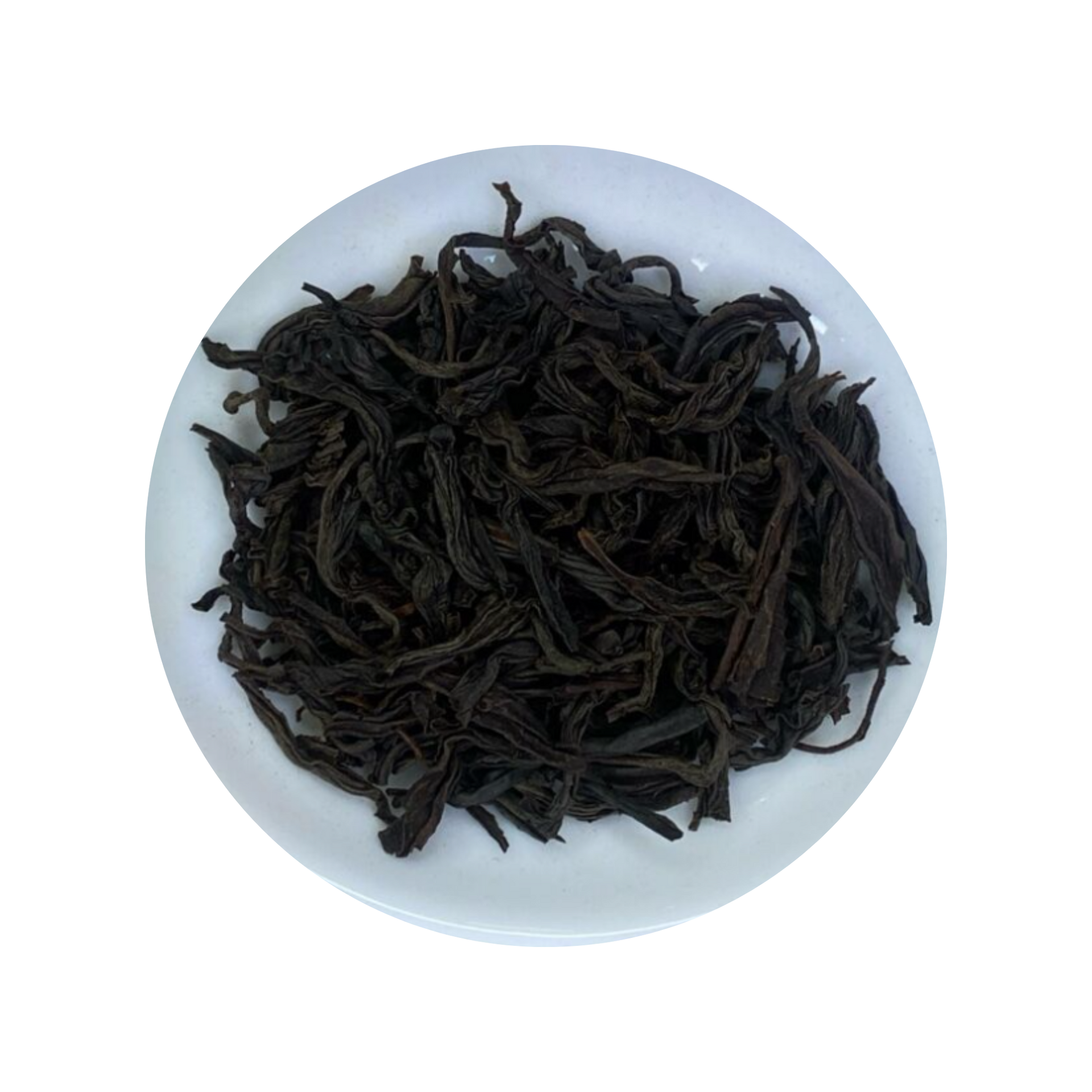 Dark curled Ceylon Black Tea leaves in a white bowl