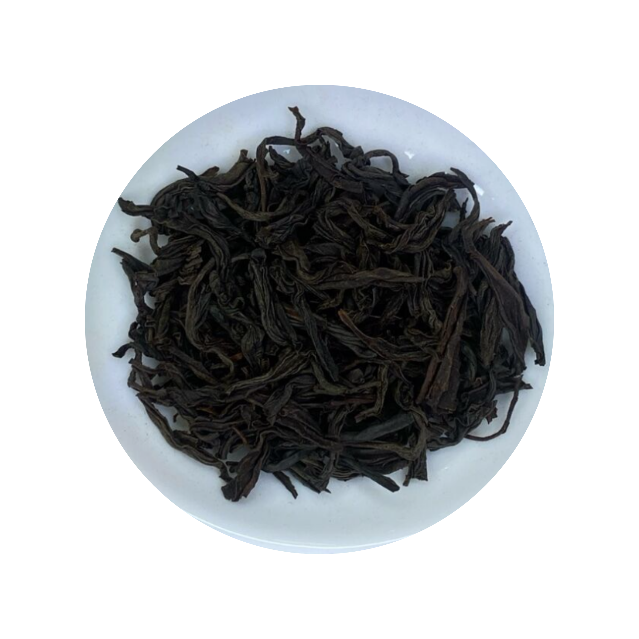 Dark curled Ceylon Black Tea leaves in a white bowl