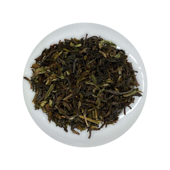 Dark Darjeeling Black tea leaves in a white bowl