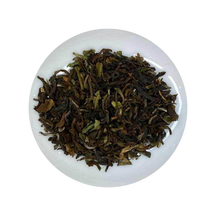 Dark Darjeeling Black tea leaves in a white bowl