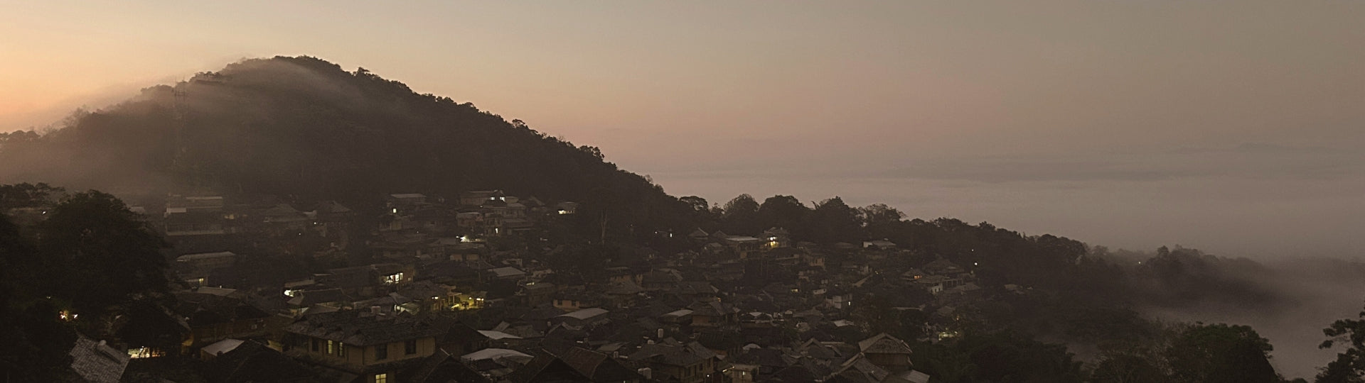 Yiwu Mountain hillside village at dawn, surrounded by mist