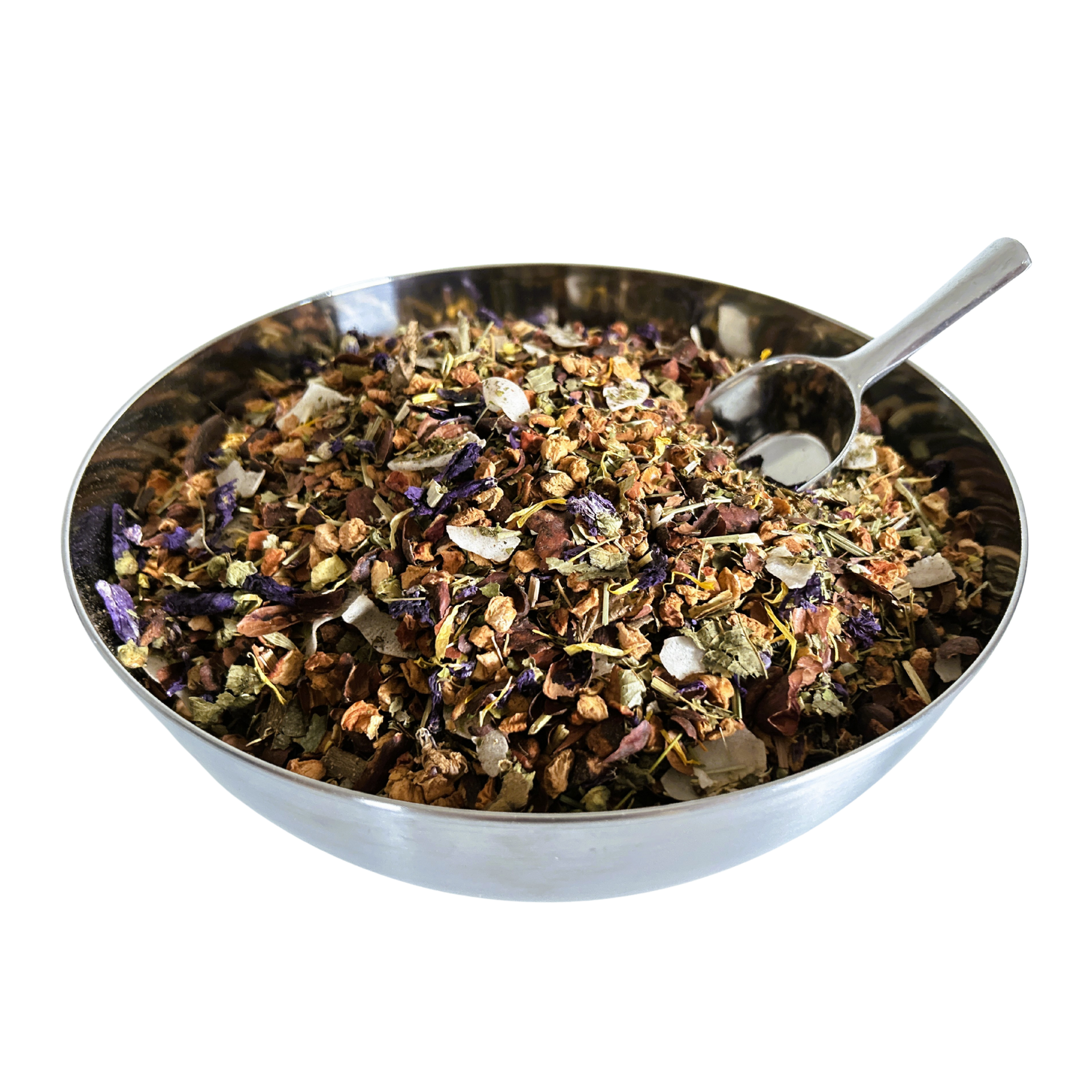 Big metal bowl full of dried herbals and flowers with a metal spoon