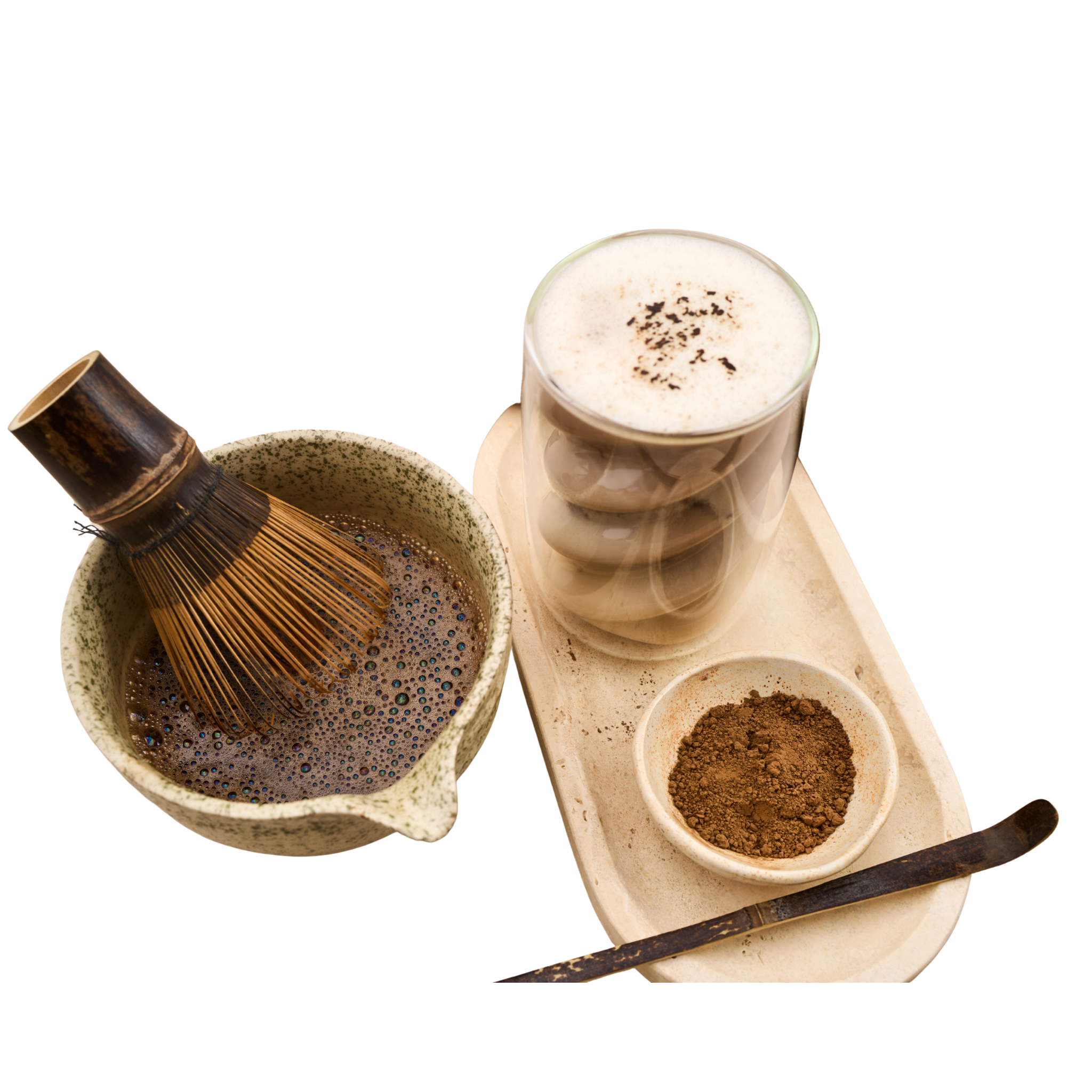 A hojicha preparation set featuring a whisk in a ceramic bowl filled with whisked hojicha powder, a glass of layered hojicha latte with foam, a small bowl of loose hojicha powder and a serving spoon