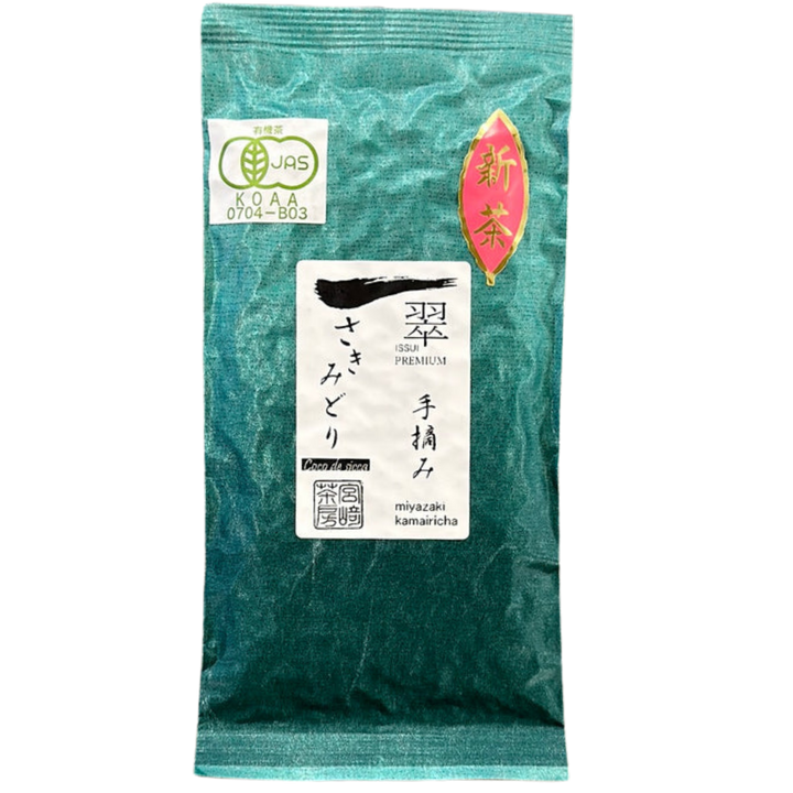 A sealed green tea pouch in a tea-green color with white and red labels