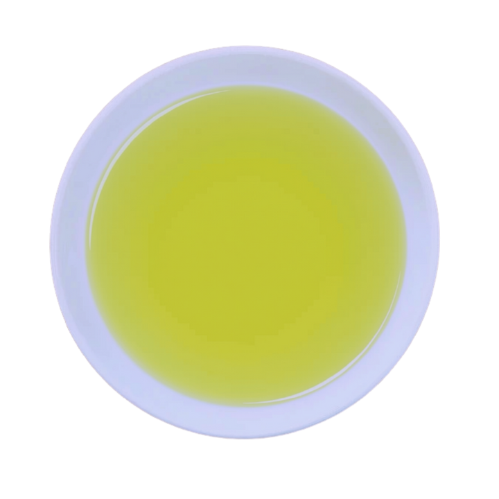 A top-down view of a white ceramic cup filled with a pale yellow-green tea