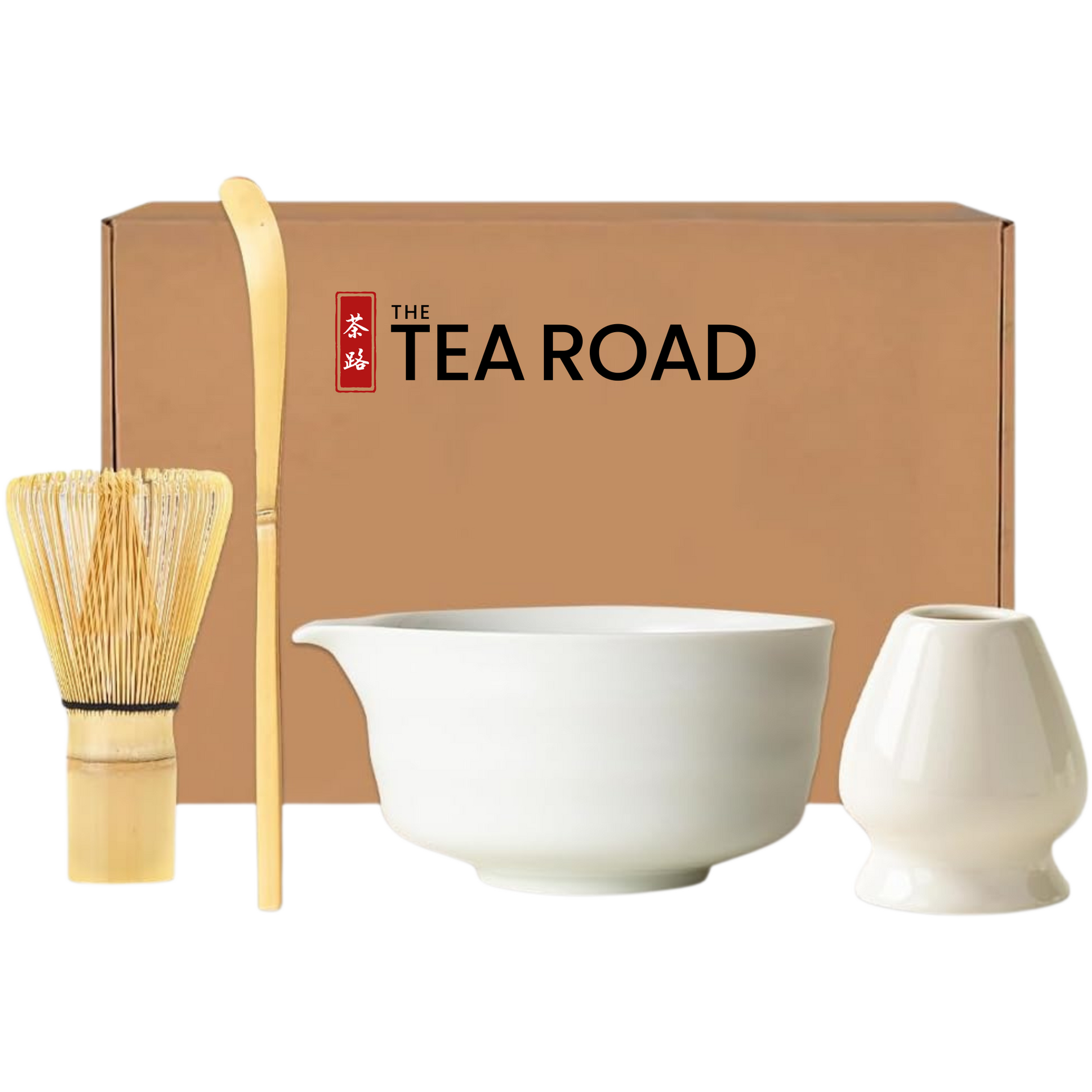 Japanese Matcha set with a white Matcha bowl with a pouring "nose" plus a whisk, a spoon and a whisk holder, all placed in front of 'The Tea Road' branded box.