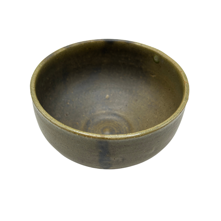 Dusty green Matcha bowl with dark patterns seen from above