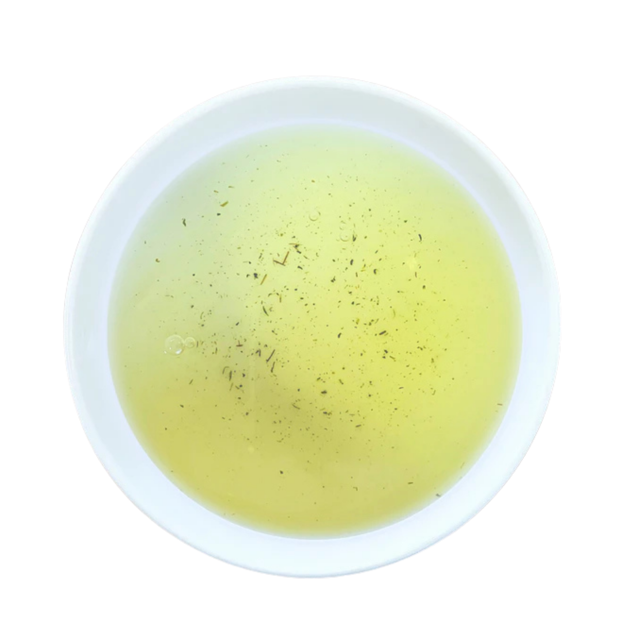 A top-down view of a white cup filled with a pale yellow tea, with small dark herb flecks at the bottom