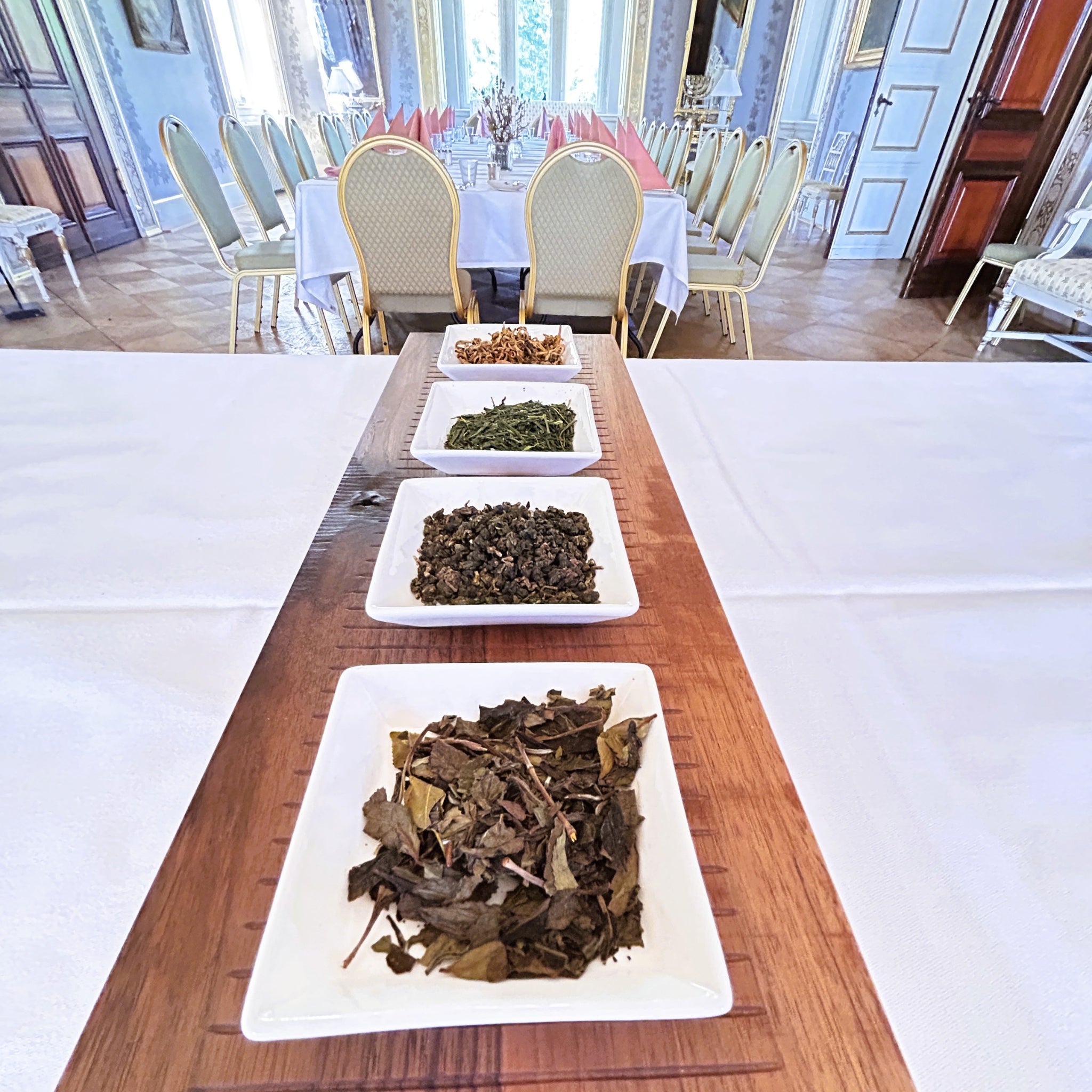 Plates of tea leaves on a wooden table at Fuglsang Herregaard ballroom