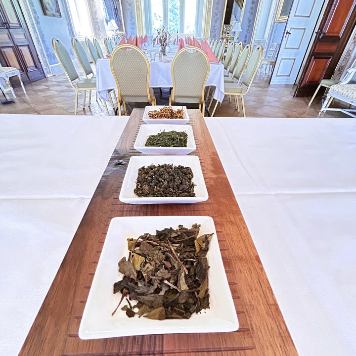 Plates of tea leaves on a wooden table at Fuglsang Herregaard ballroom