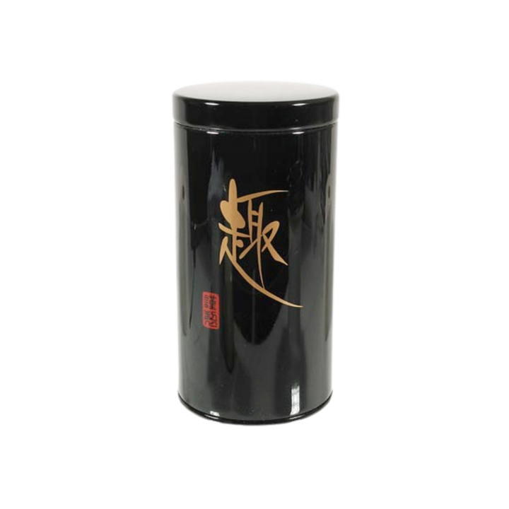 Black cylindrical tea container with gold and red text