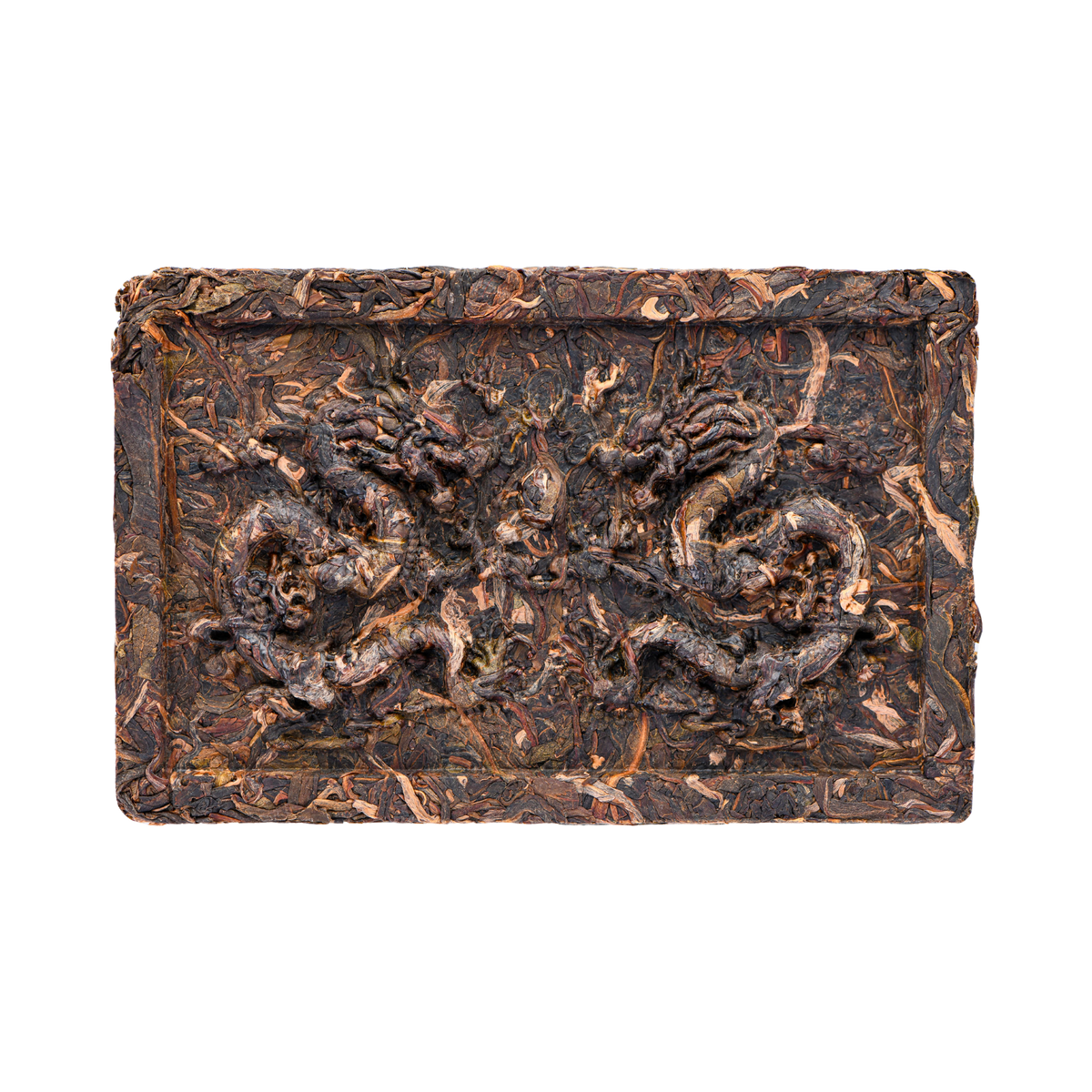 Compressed square tea cake with dark-brown and lighter brown tea leaves and two dragons formed by the compression