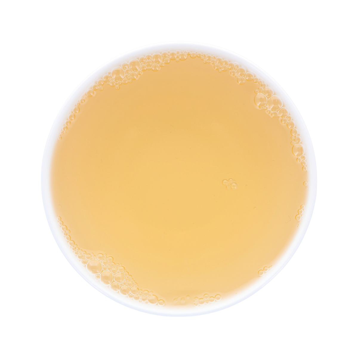 Warm-yellow tea soup in a white porcelain cup