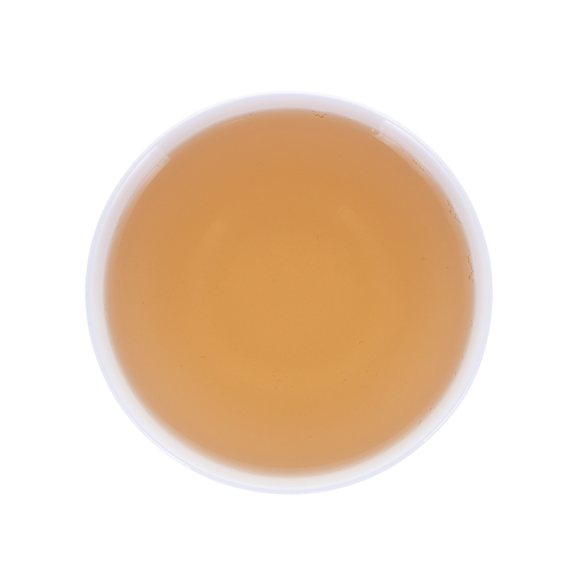 Round cup with yellow-reddish brewed tea