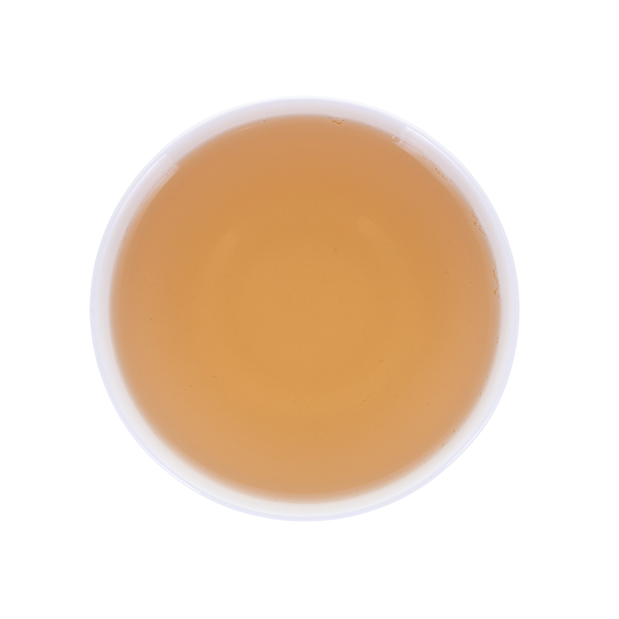 Round cup with yellow-reddish brewed tea