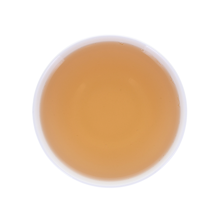 Round cup with yellow-reddish brewed tea