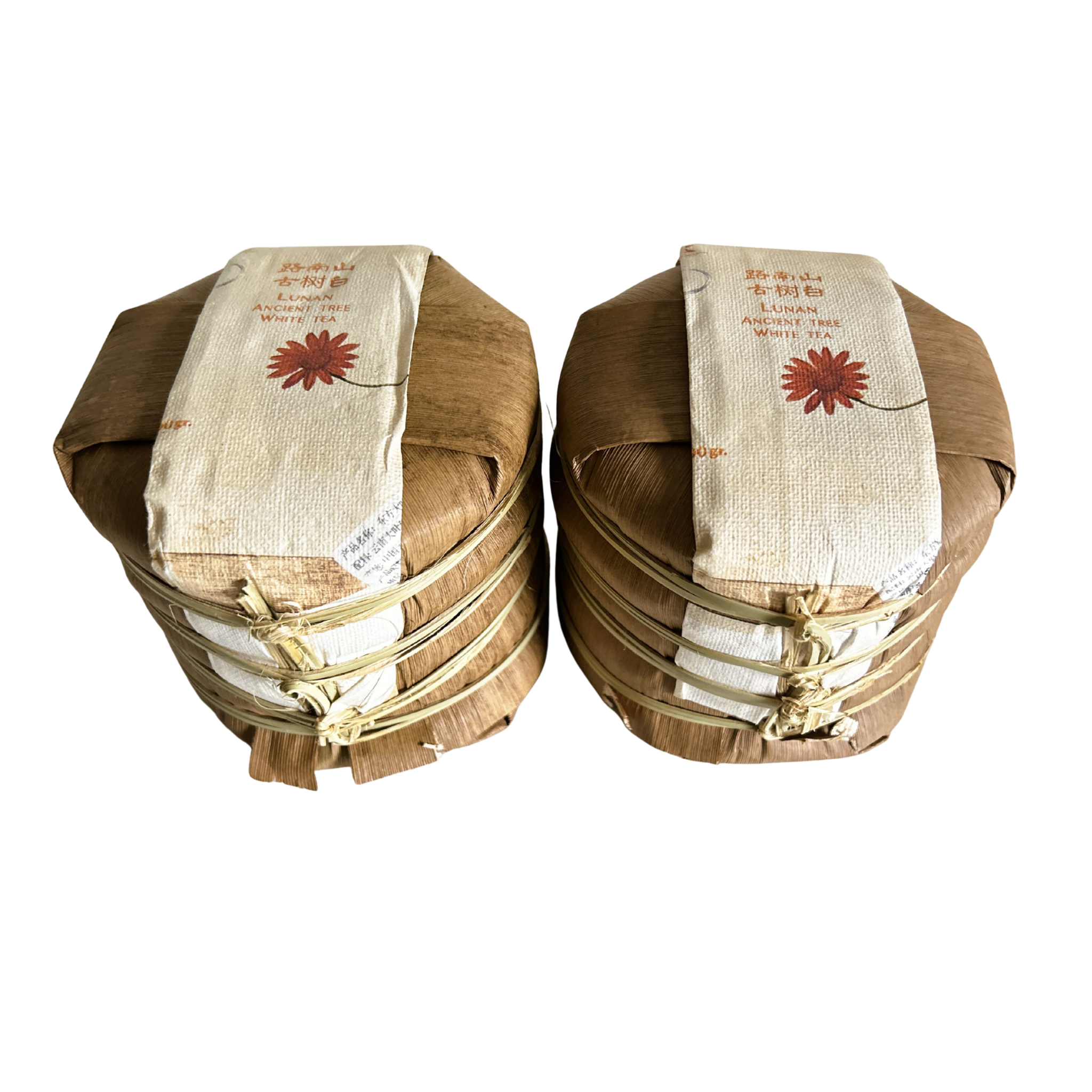 Two wooden baskets made of banana leaves holding each 5 white tea cakes