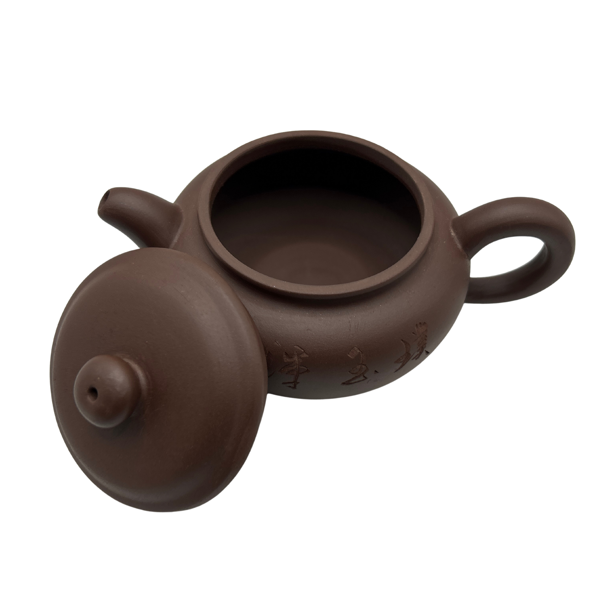 Brown ceramic teapot with lid on the side