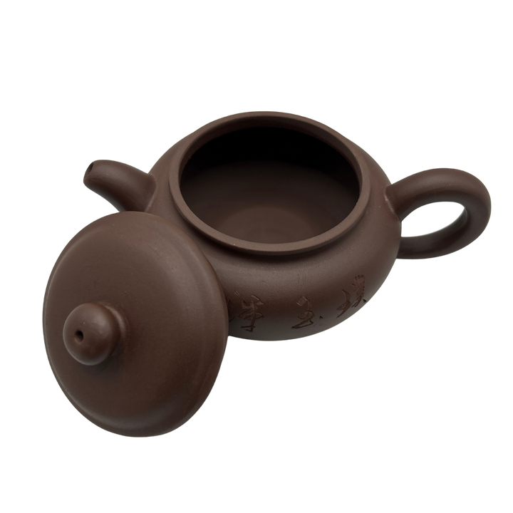 Brown ceramic teapot with lid on the side