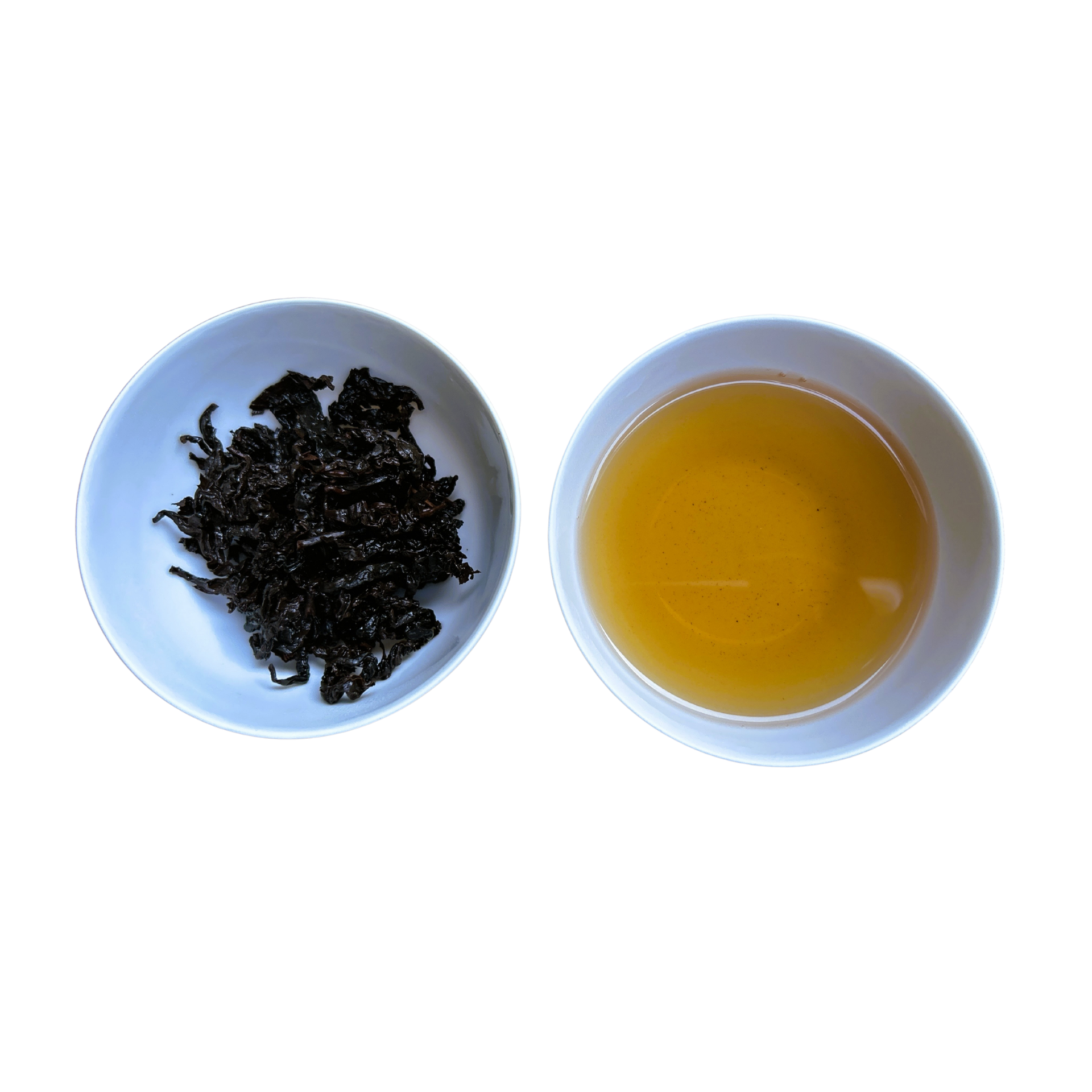 Two white bowls, one with wet tea leaves and the other with brewed tea